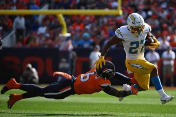 Los Angeles Chargers running back J.K. Dobbins (27) runs with the football as Denver Broncos sa ...