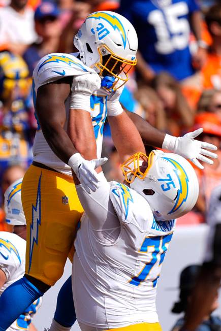 Los Angeles Chargers running back Kimani Vidal (30) celebrates with center Bradley Bozeman (75) ...