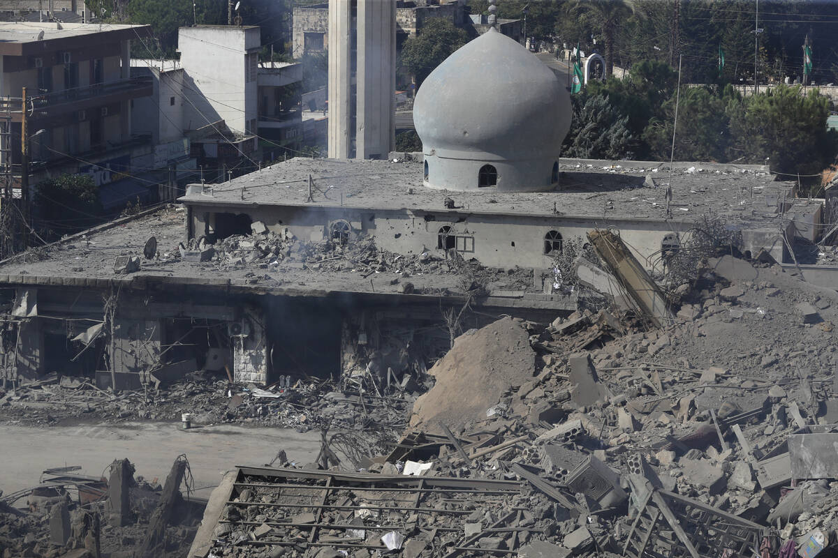 Destroyed shops and a mosque are seen on a commercial street that was hit Saturday night by Isr ...