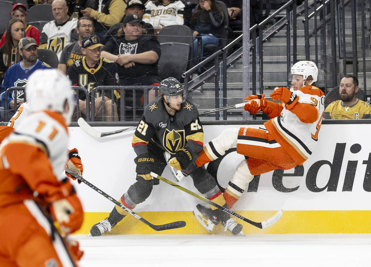 Golden Knights center Brett Howden (21) delivers a blow on Anaheim Ducks center Leo Carlsson (9 ...