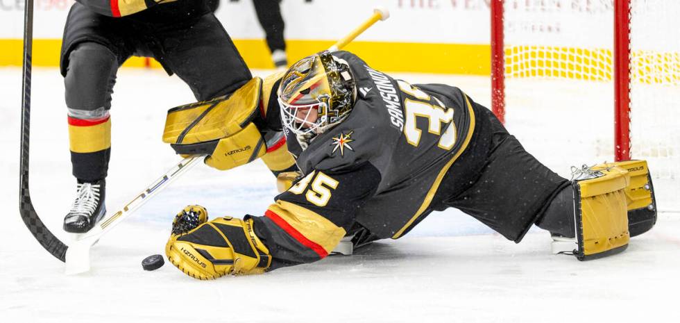 Golden Knights goaltender Ilya Samsonov (35) attempts to cover the puck during the second perio ...