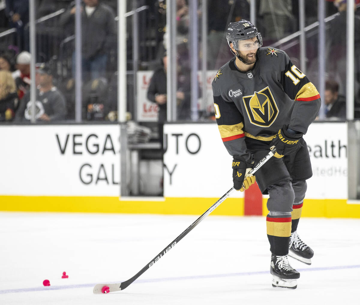 Golden Knights center Nicolas Roy (10) looks to shoot a pink duck that was thrown on the ice in ...