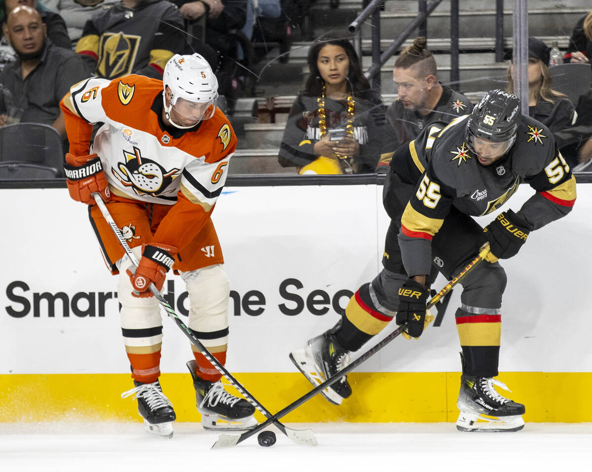 Golden Knights right wing Keegan Kolesar (55) and Anaheim Ducks defenseman Brian Dumoulin (6) c ...