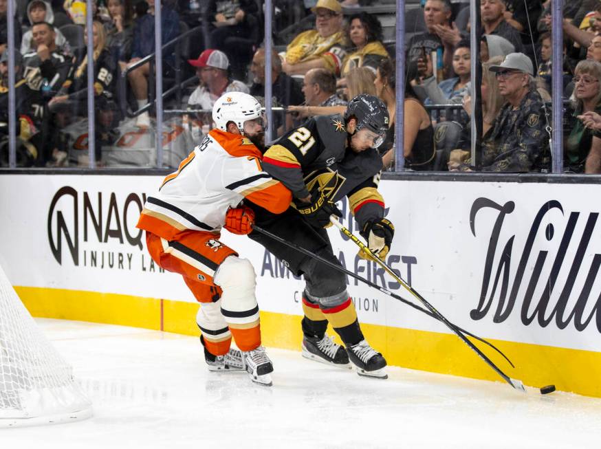 Golden Knights center Brett Howden (21) and Anaheim Ducks defenseman Radko Gudas (7) compete fo ...