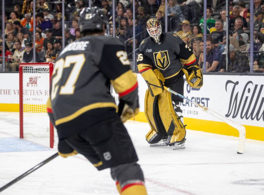 Golden Knights goaltender Ilya Samsonov (35) settles a puck for defenseman Shea Theodore (27) t ...