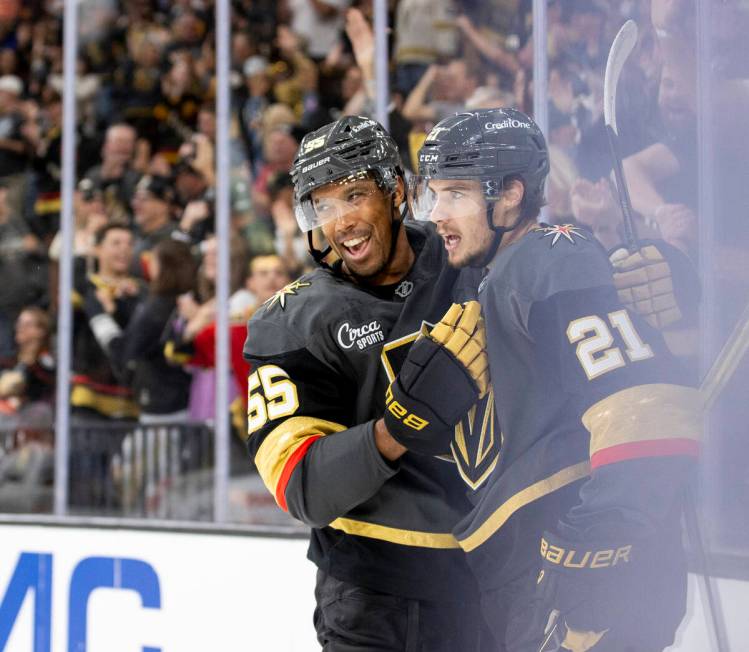 Golden Knights center Brett Howden (21) celebrates scoring a goal with right wing Keegan Kolesa ...