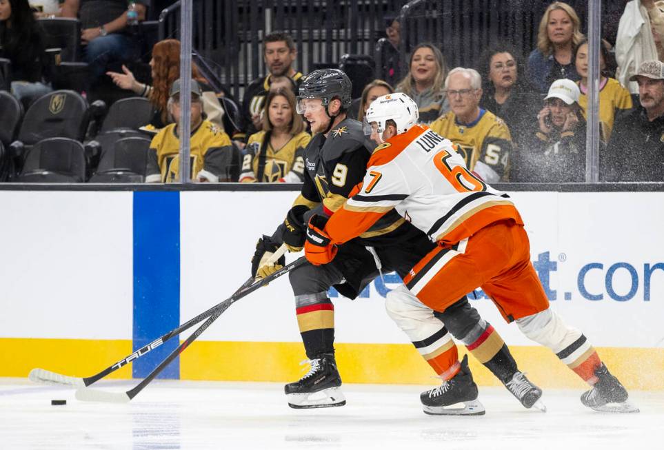 Golden Knights center Jack Eichel (9) and Anaheim Ducks defenseman Tristan Luneau (67) compete ...