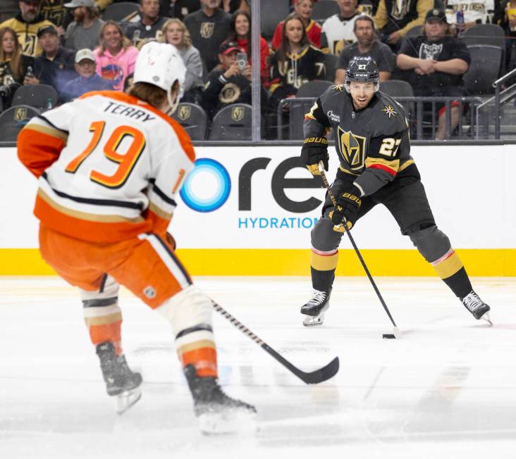 Golden Knights defenseman Shea Theodore (27) handles the puck during the first period of t ...