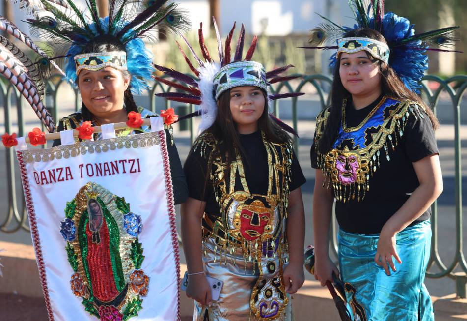 Members of the Danza Tonantzi Guadalupana Las Vegas dance group, Candelaria Cruise, 12, left, D ...