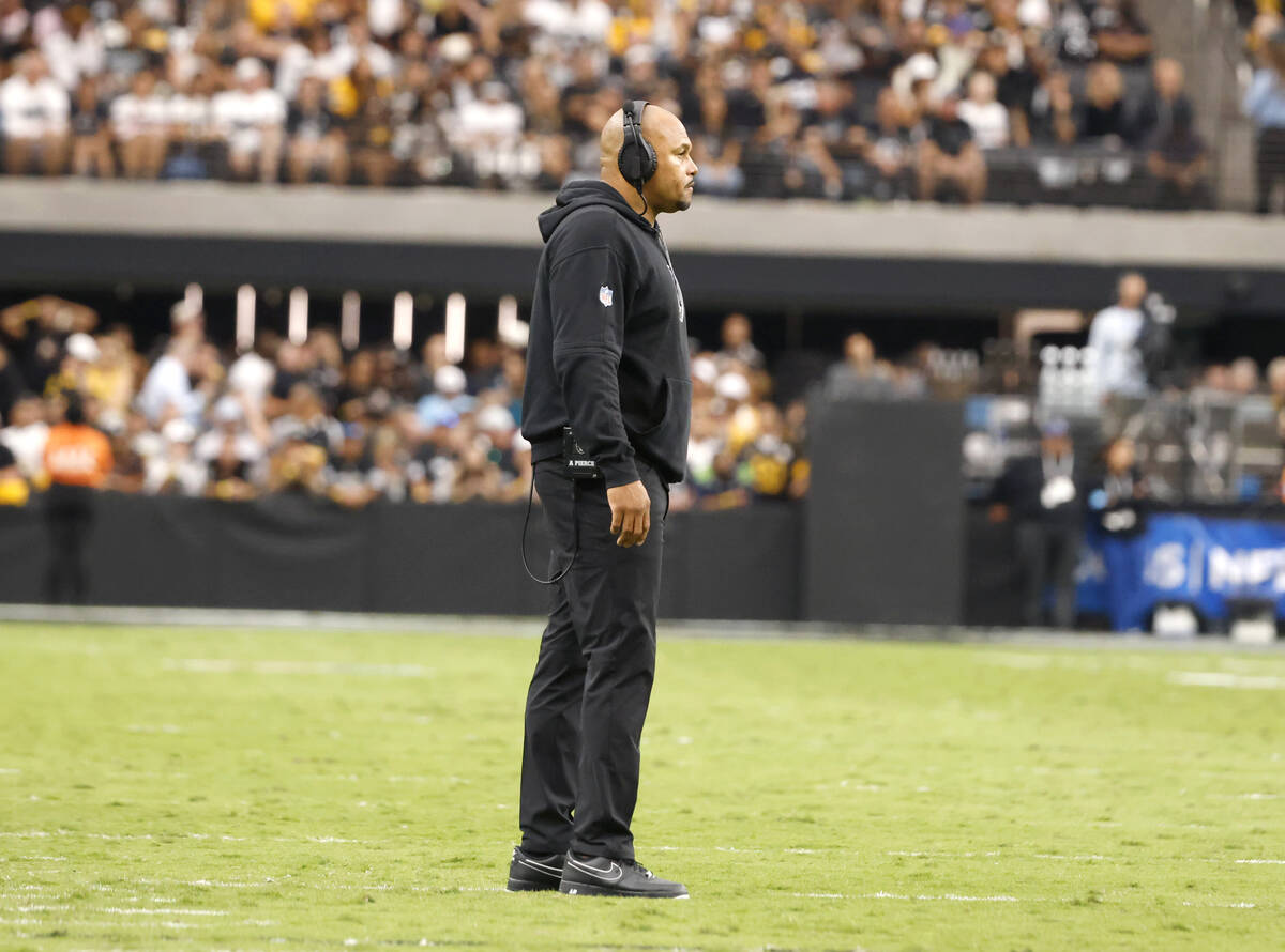 Raiders head coach Antonio Pierce stands on the field during a time out during the first half o ...