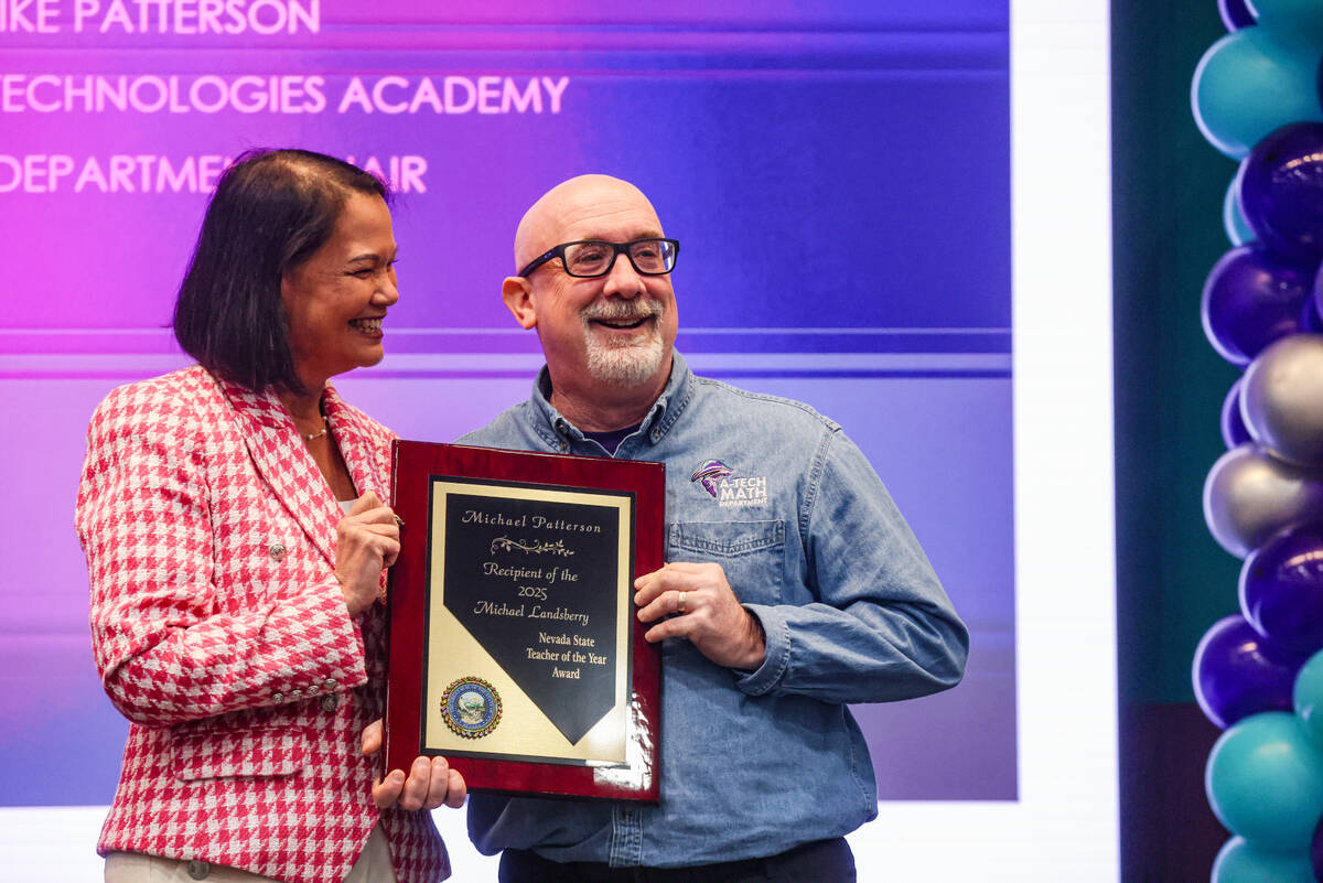 Superintendent of Public Instruction Jhone Ebert, left, holds the 2025 Nevada State Teacher of ...