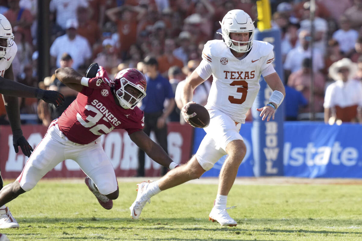 Texas Longhorns quarterback Quinn Ewers (3) runs away from Oklahoma Sooners defensive lineman R ...