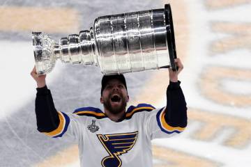 St. Louis Blues' David Perron carries the Stanley Cup after the Blues defeated the Boston Bruin ...