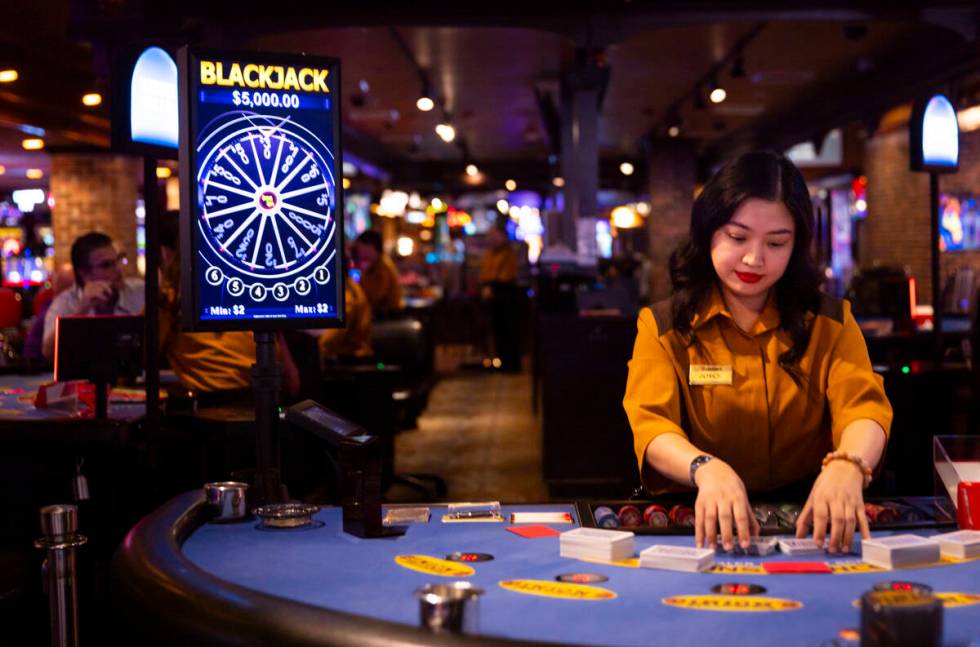 Dealer Joyce Ramos shuffles cards at a blackjack table at Binion’s on Thursday, Oct. 10, ...