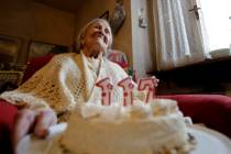 FILE- Emma Morano holds a cake with candles marking 117 years on the day of her birthday, Nov. ...