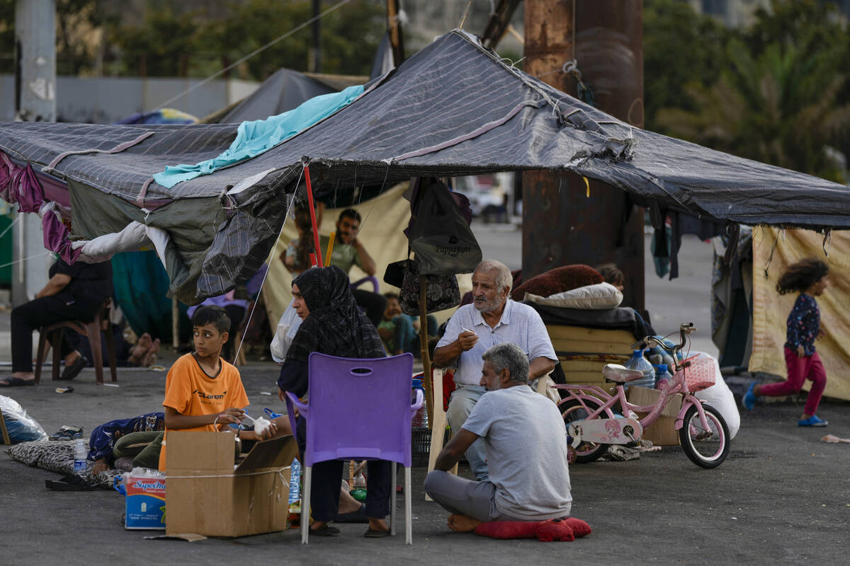 Families fleeing Israeli airstrikes in the south, sit in Martyrs' square, in Beirut, Lebanon, M ...