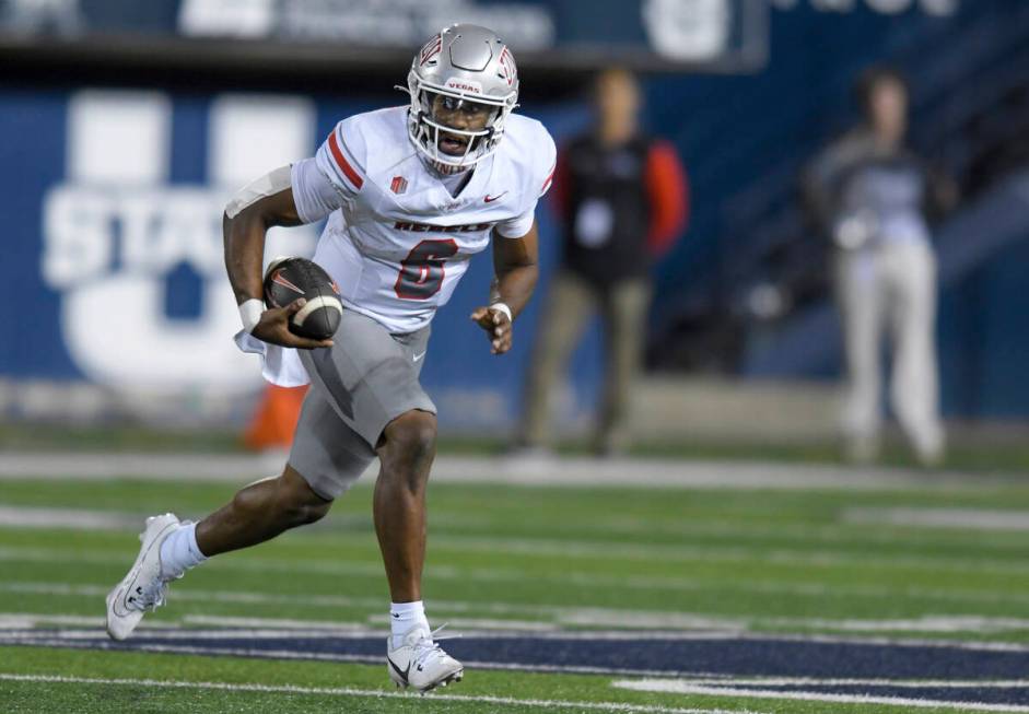 UNLV quarterback Hajj-Malik Williams (6) scrambles out of the pocket against Utah State in the ...