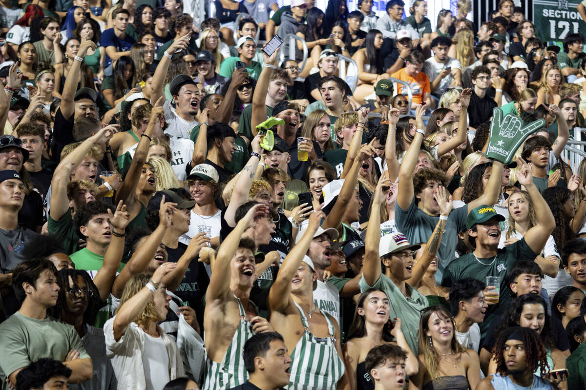 Fans for the Hawaii Rainbow Warriors cheer during the second half of an NCAA college football g ...