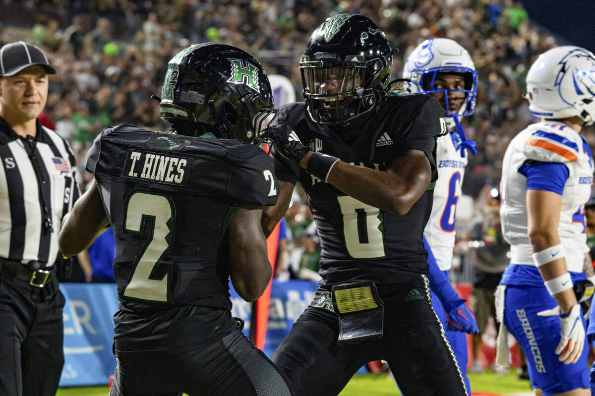 Hawaii wide receiver Tylan Hines (2) celebrates his touchdown with teammate Alex Perry (0) duri ...