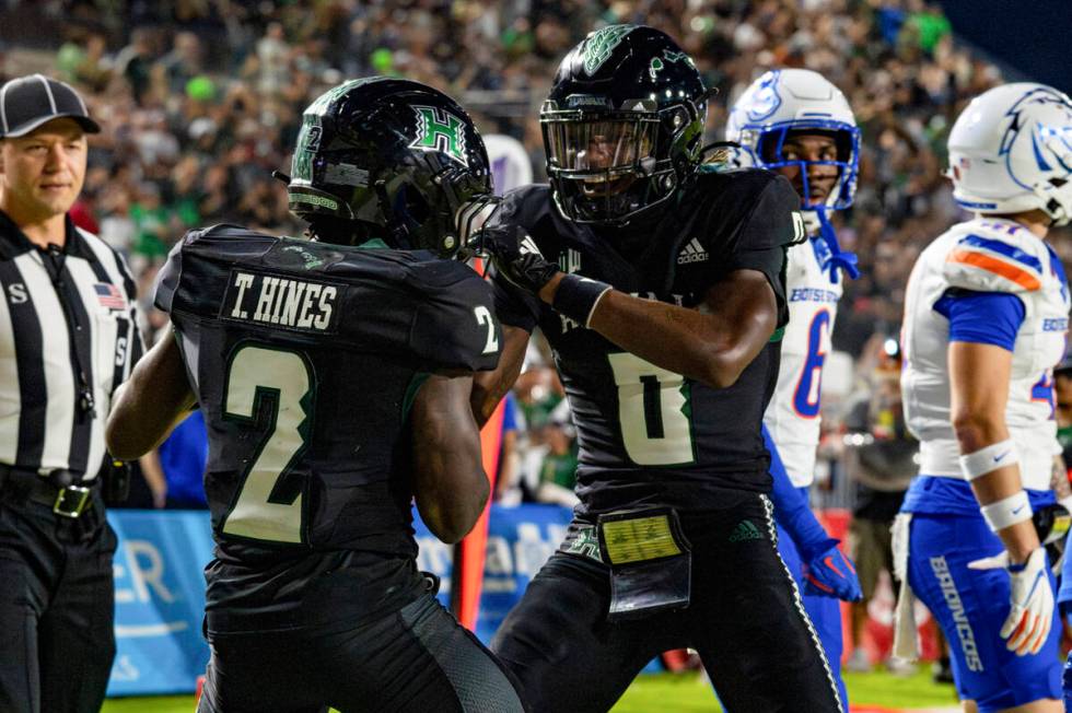 Hawaii wide receiver Tylan Hines (2) celebrates his touchdown with teammate Alex Perry (0) duri ...