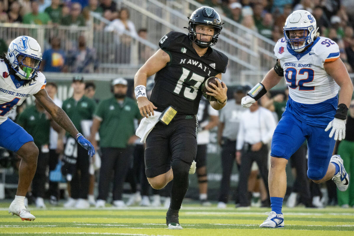 Hawaii quarterback Brayden Schager (13) runs the ball during the first half of an NCAA college ...