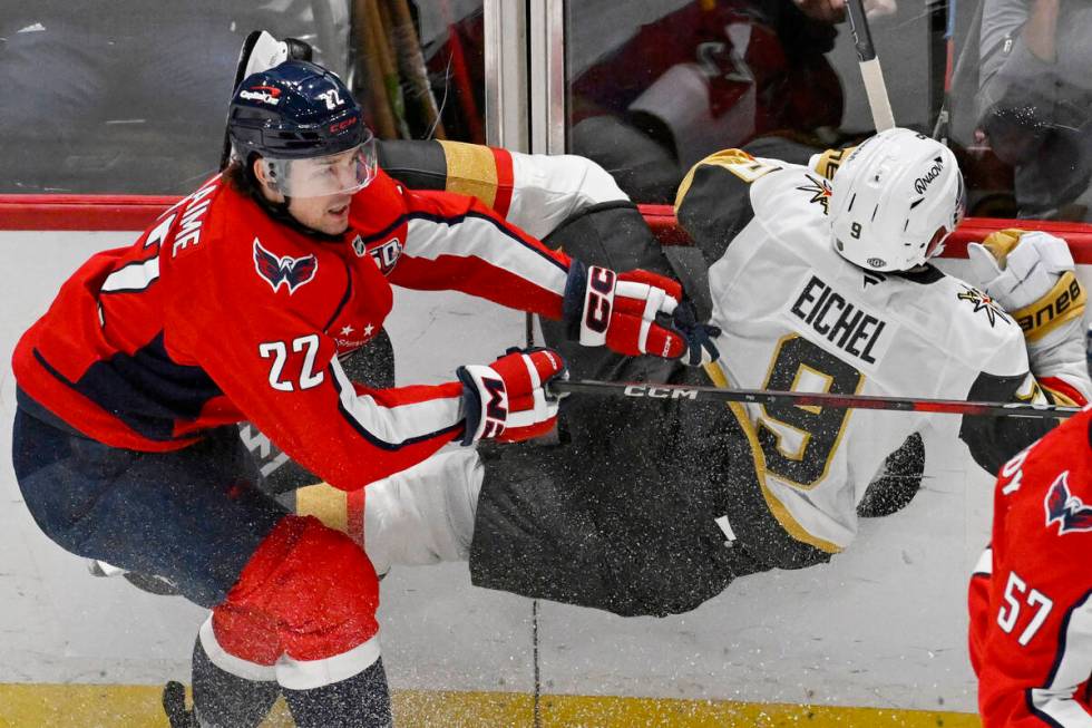 Washington Capitals right wing Brandon Duhaime (22) checks Vegas Golden Knights center Jack Eic ...