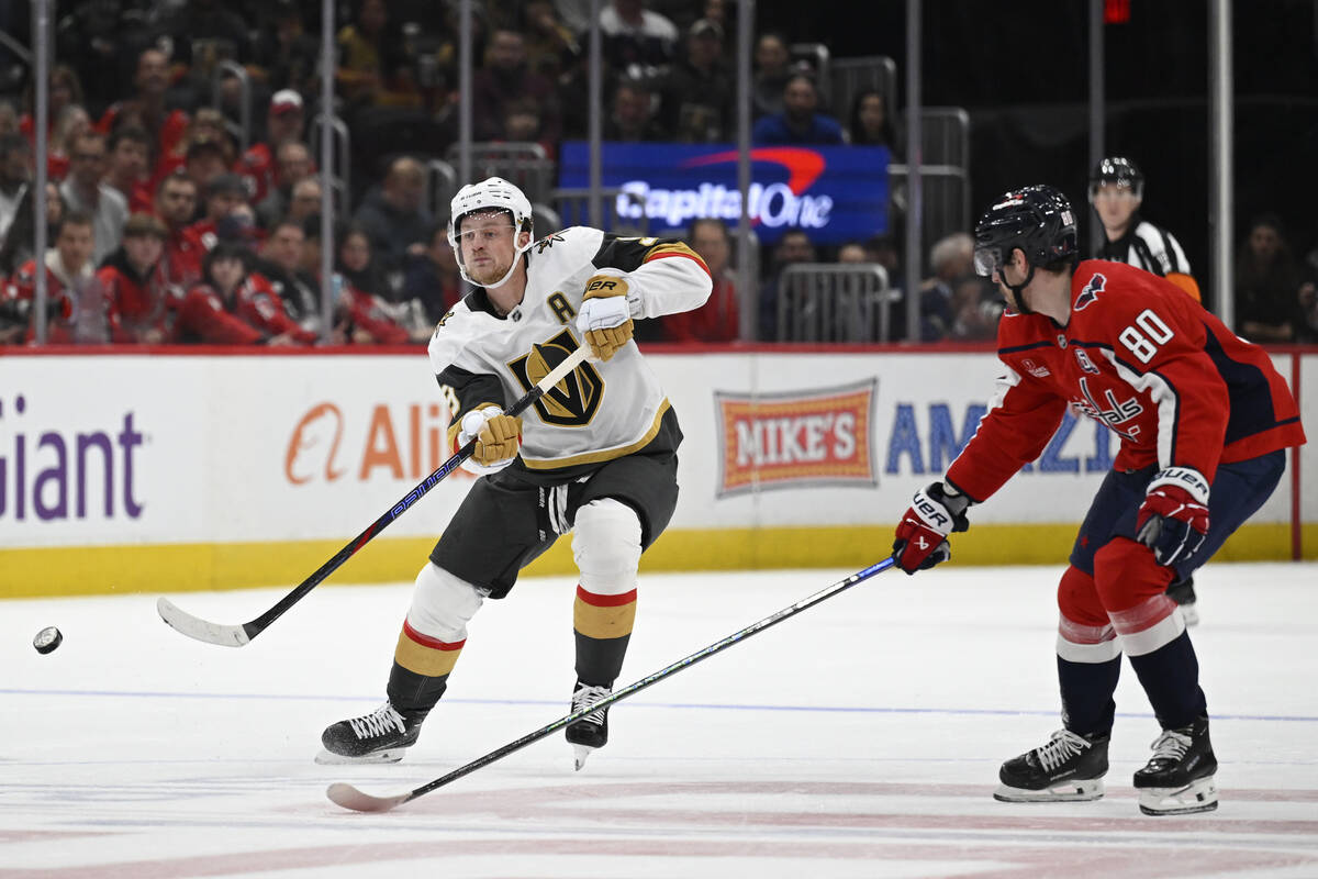 Vegas Golden Knights center Jack Eichel, left, passes the puck against Washington Capitals left ...