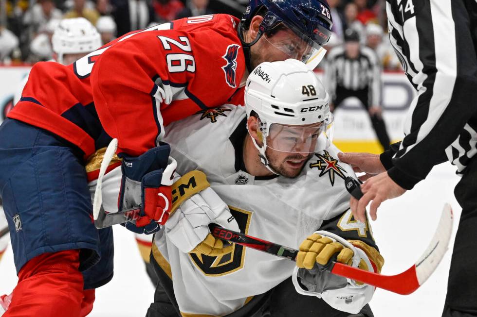 Washington Capitals center Nic Dowd (26) and Vegas Golden Knights center Tomas Hertl are tangle ...