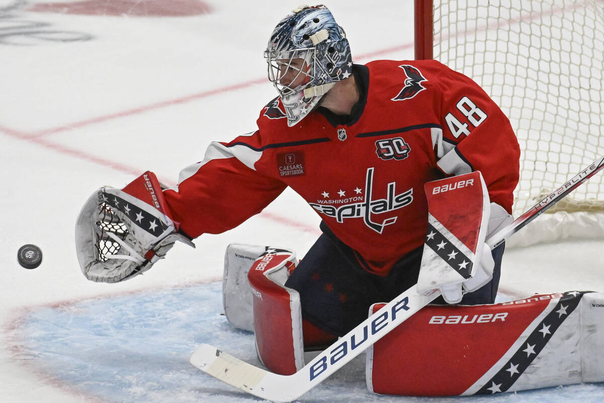 Washington Capitals goaltender Logan Thompson catches a shot during the third period of an NHL ...