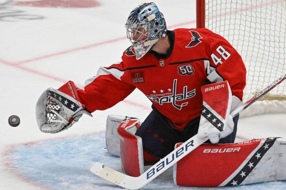 Washington Capitals goaltender Logan Thompson catches a shot during the third period of an NHL ...