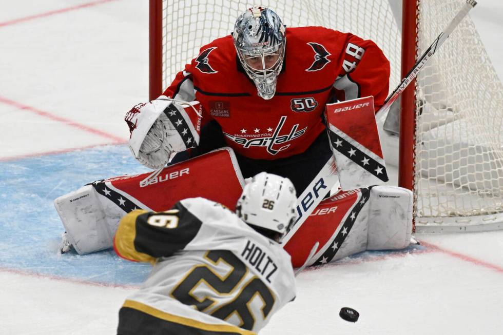 Washington Capitals goaltender Logan Thompson blocks a shot by Vegas Golden Knights right wing ...