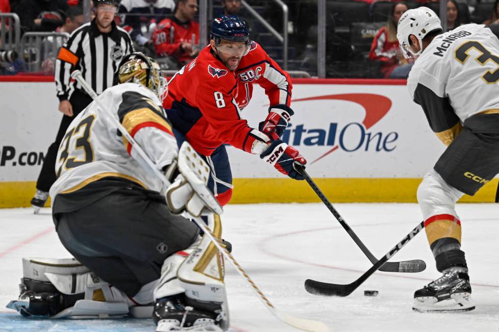 Washington Capitals left wing Alex Ovechkin, center, attempts a shot against Vegas Golden Knigh ...