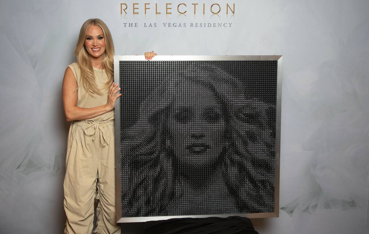 Carrie Underwood is shown with the dice clock AEG Presents presented to her for her 41st birthd ...