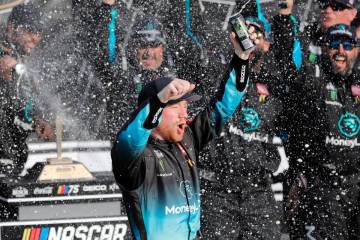 Tyler Reddick celebrates in Victory Lane after winning a NASCAR Cup Series auto race at Kansas ...