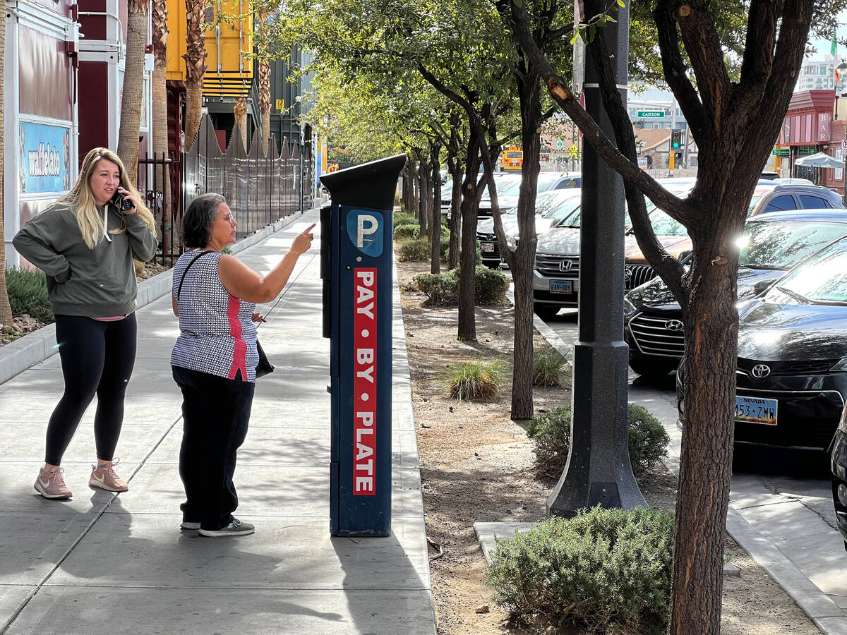 Marta Buchanan of Tucson, Ariz., pays for parking at a payment machine on 7th Street in downtow ...