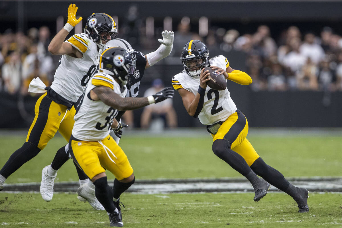 Pittsburgh Steelers quarterback Justin Fields (2) rushes past Vegas Raiders defensive end Maxx ...