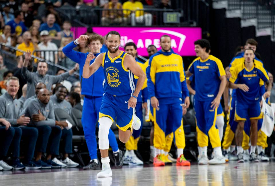 Golden State Warriors guard Stephen Curry (30) celebrates a basket during the NBA preseason bas ...