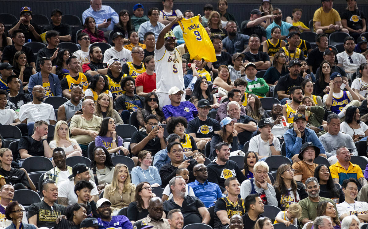 A Los Angeles Lakers fan holds up a Bronny James Jr. jersey as chants calling for him to play r ...