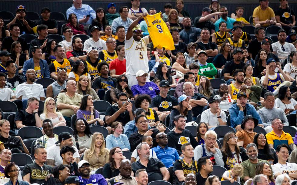 A Los Angeles Lakers fan holds up a Bronny James Jr. jersey as chants calling for him to play r ...