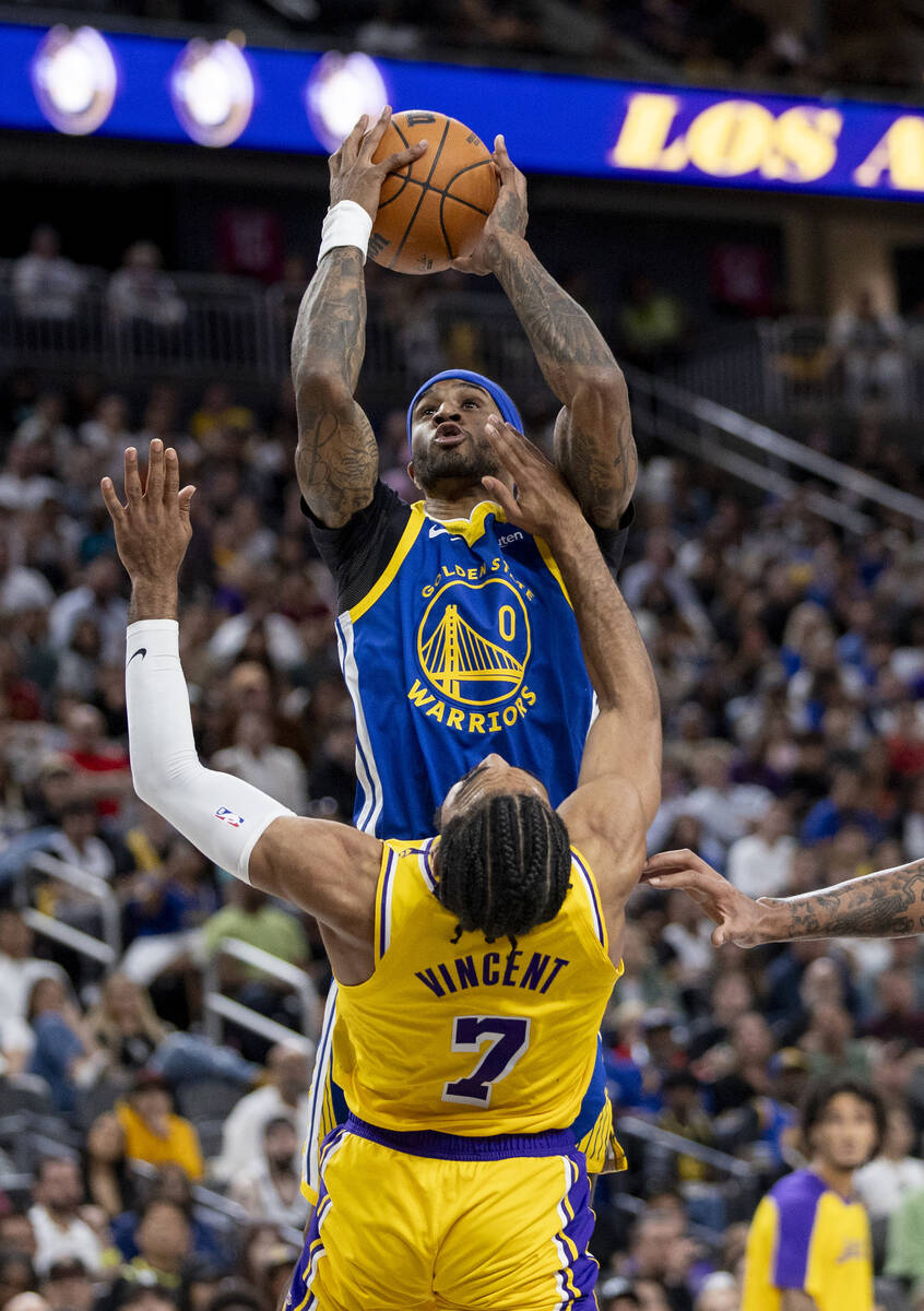 Golden State Warriors guard Gary Payton II (0) shoots the ball over Los Angeles Lakers guard Ga ...