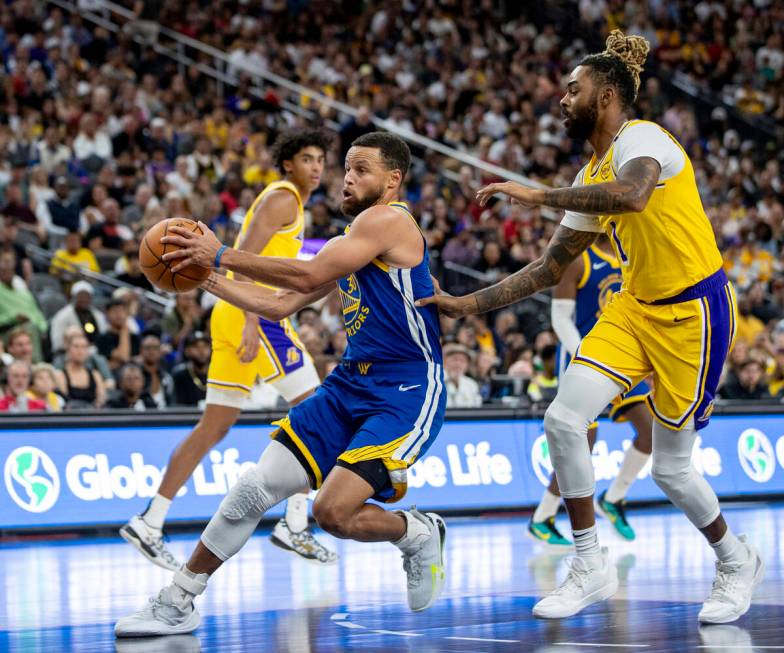 Golden State Warriors guard Stephen Curry (30) drives toward the hoop during the NBA preseason ...