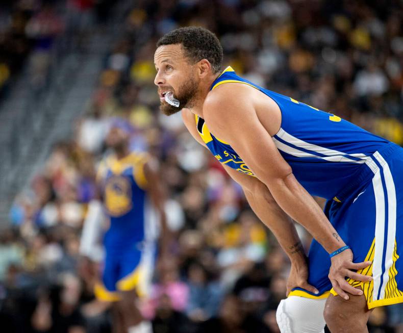 Golden State Warriors guard Stephen Curry (30) watches a free throw during the NBA preseason ba ...