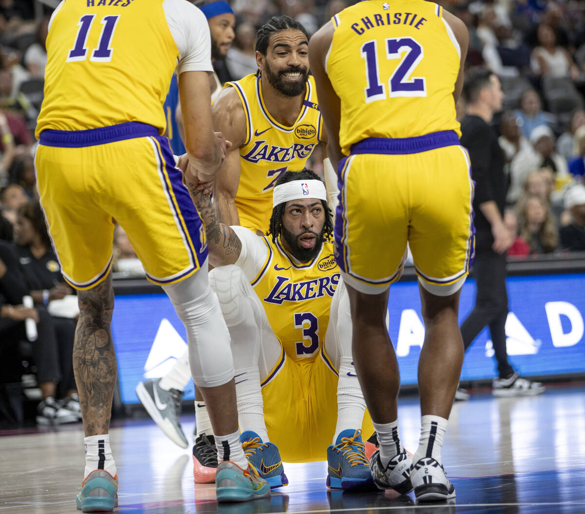 Los Angeles Lakers forward Anthony Davis (3) is helped up by three other teammates during the N ...