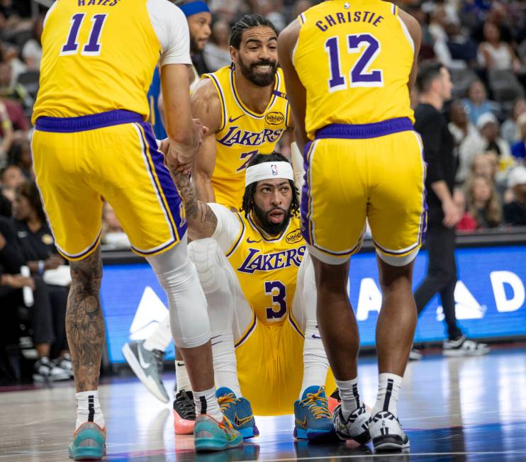 Los Angeles Lakers forward Anthony Davis (3) is helped up by three other teammates during the N ...