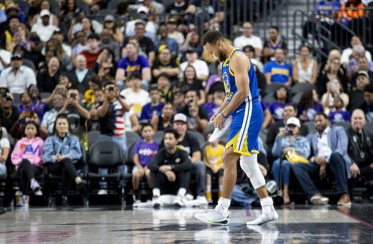 Golden State Warriors guard Stephen Curry (30) looks to put his shoe back on during the NBA pre ...