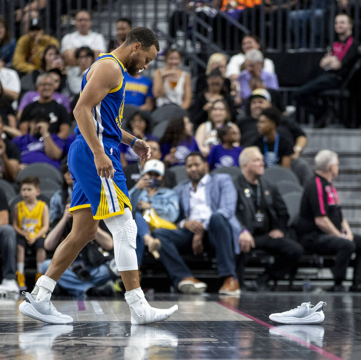 Golden State Warriors guard Stephen Curry (30) looks to grab his missing shoe during the NBA pr ...