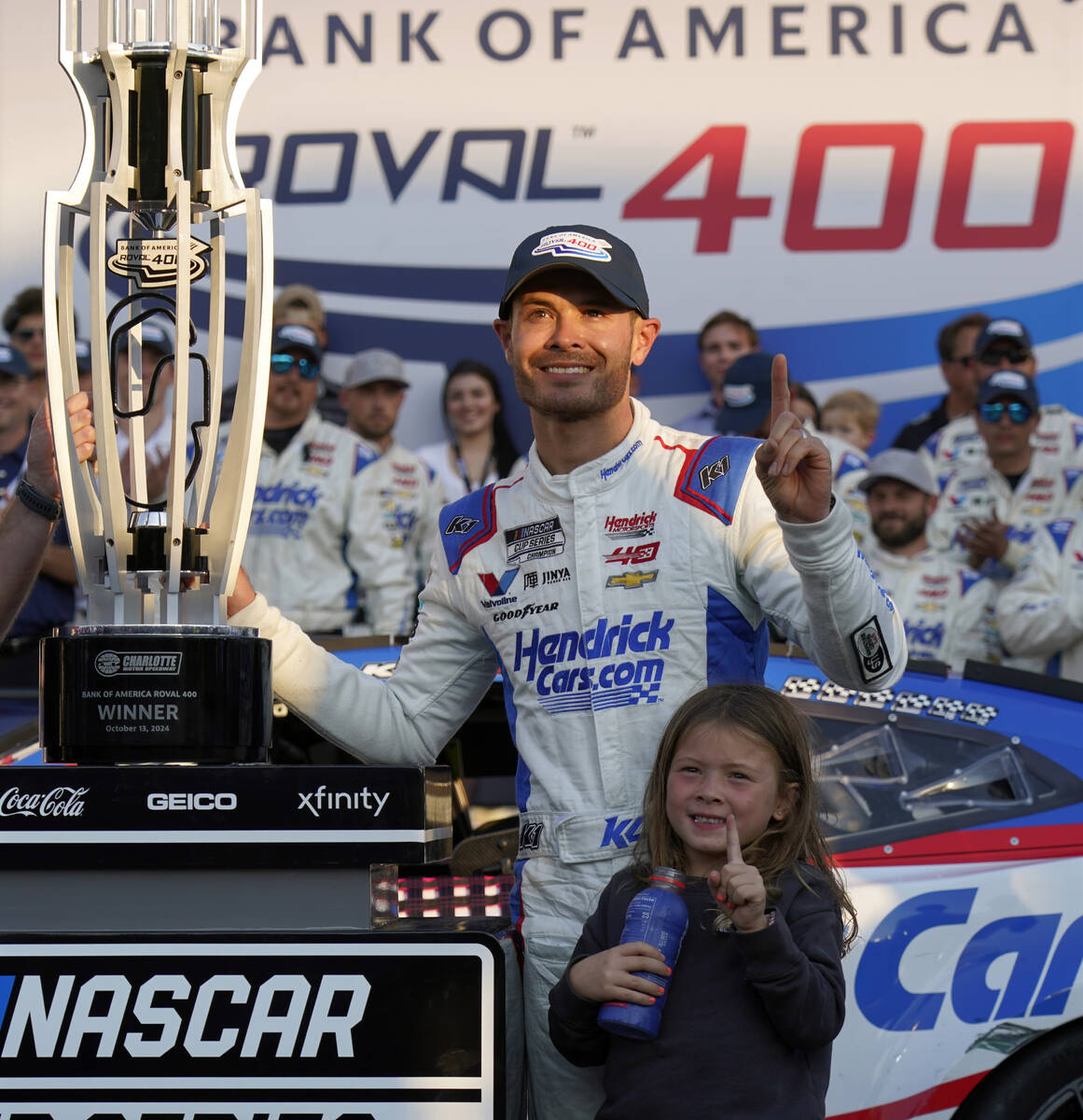 Kyle Larson poses with the trophy with his daughter Audrey, 6, after winning a NASCAR Cup Serie ...