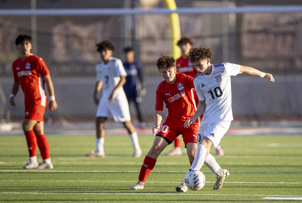 Las Vegas High senior Daniel Murillo (10) and Coronado midfielder Aiden Sena (10) compete for t ...