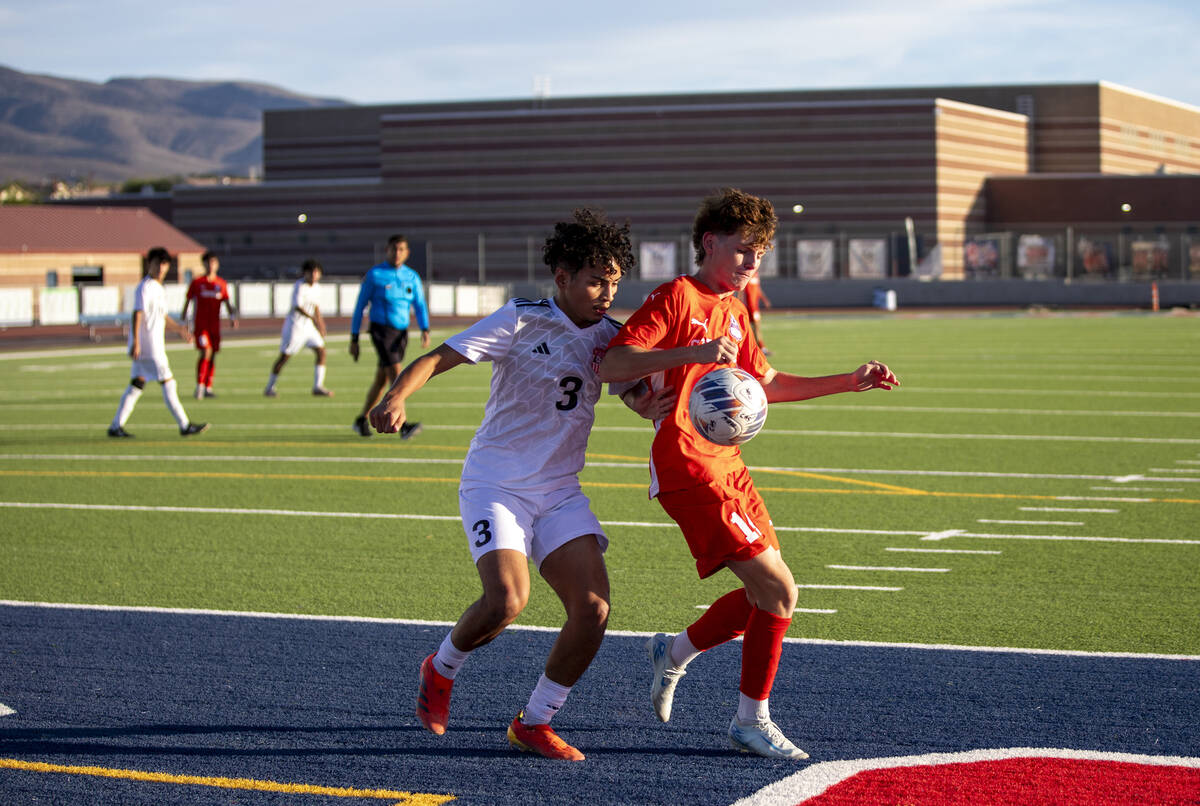 Coronado junior Gavin Flickinger (11) and Las Vegas High senior Ariel Lopez (3) compete for the ...