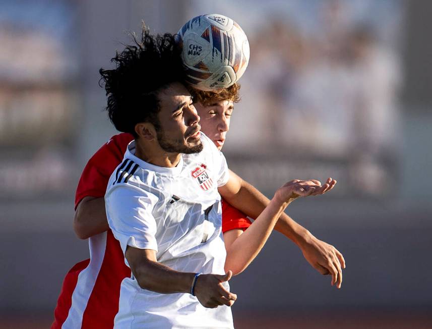 Las Vegas High junior Anthony Cardenas, front, and Coronado defender Ignacio Ramirez, back, com ...